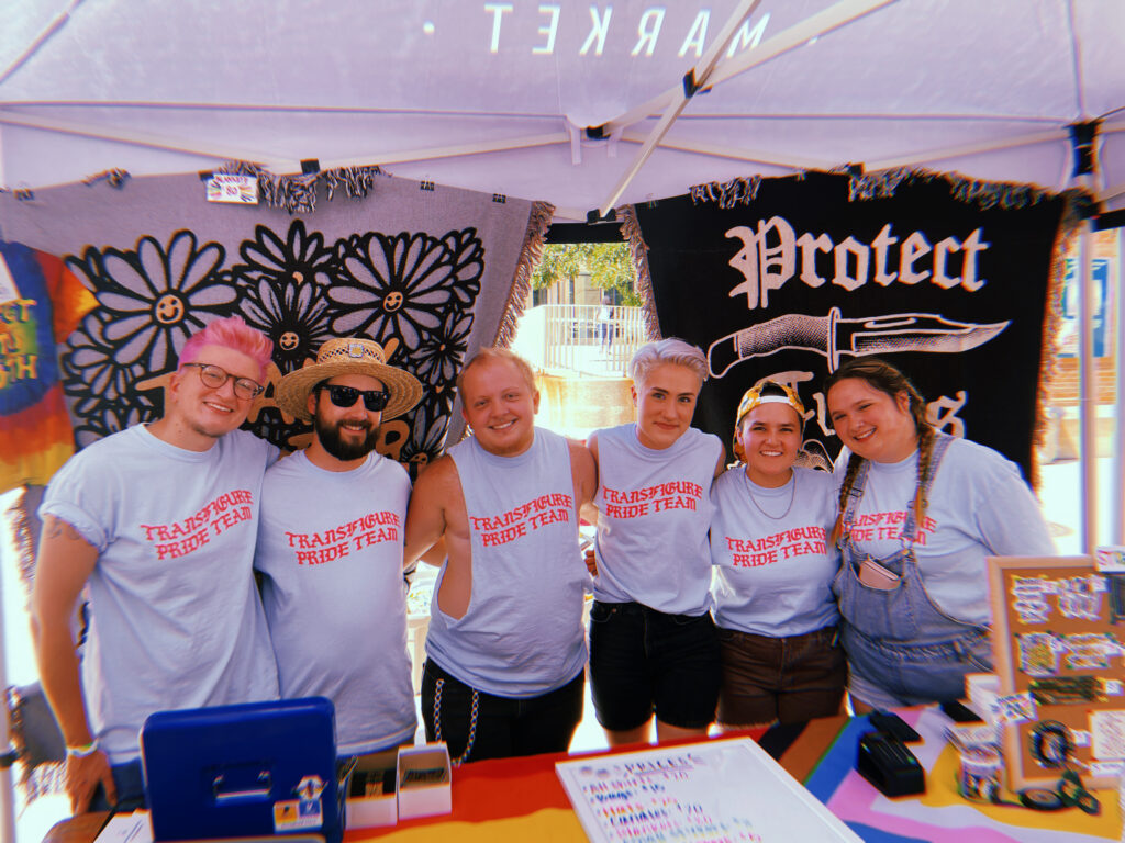 Bailey (center left) and friends at a Transfigure Print Co. Pride pop up