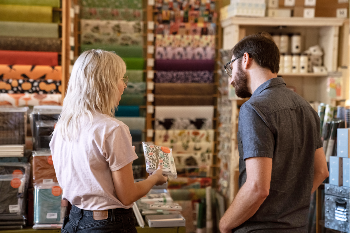 A retail store owner speaks with a customer