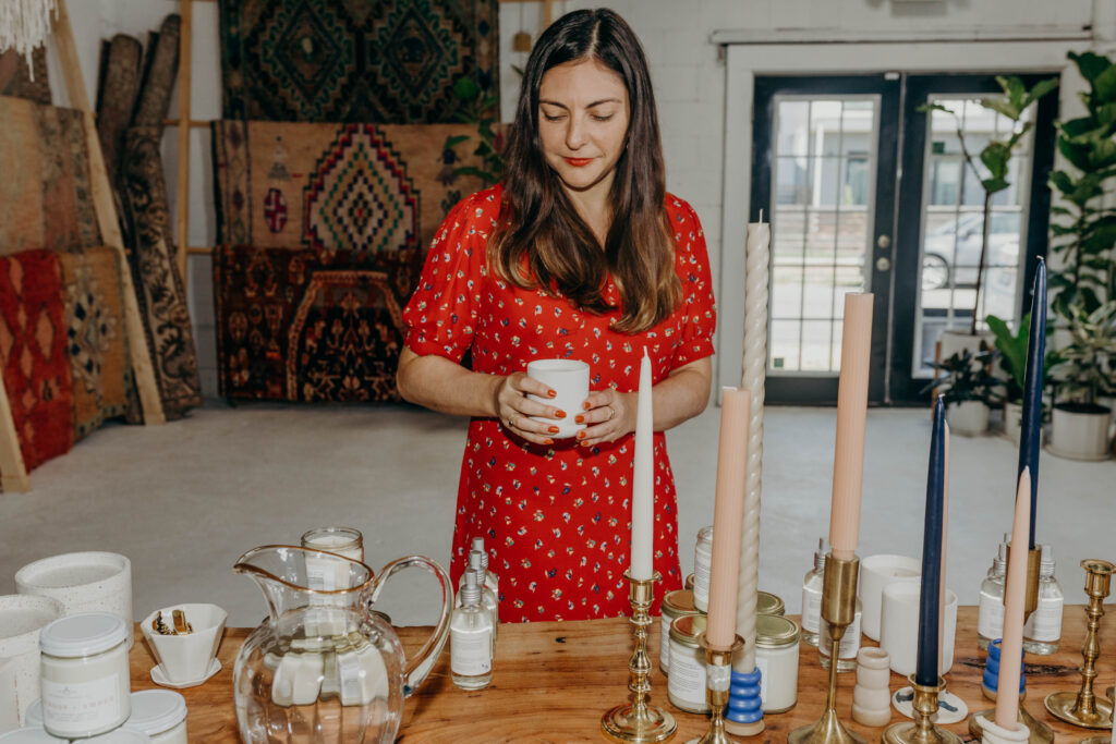 A shopper picks up a candle in a store