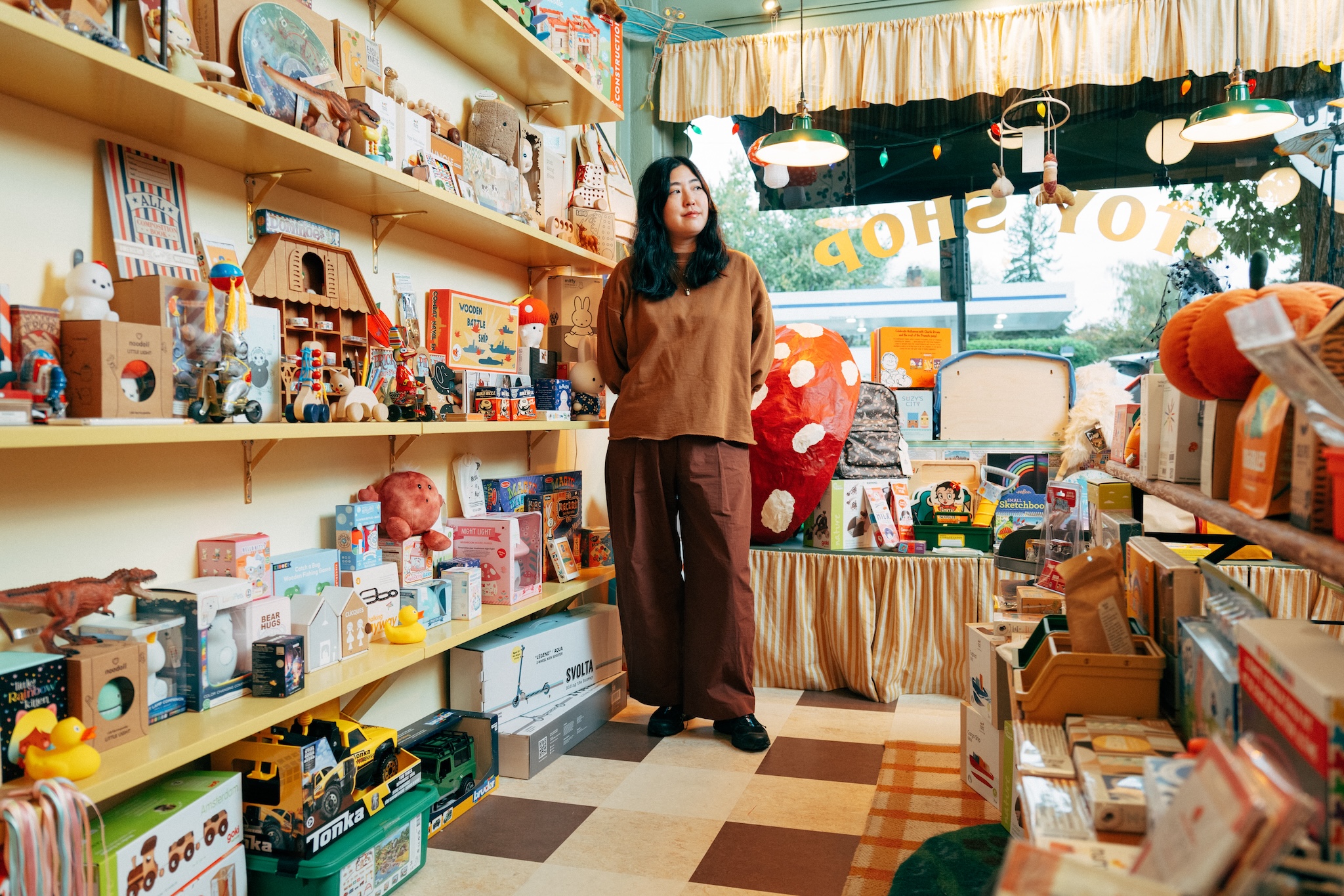 a shopkeeper stands in her toy store